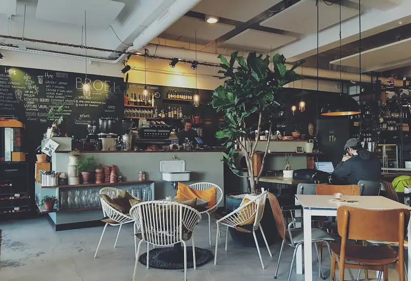 Cafe interior with wood tables and warm light